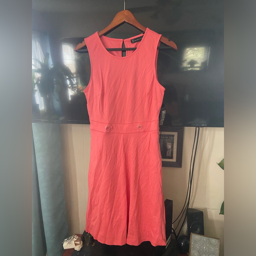 Peach colored dress with button accents and pockets